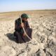 Climate change and pollution threaten Iraq's ancient marshes 6 A Marsh Arab man looks at a dry ground