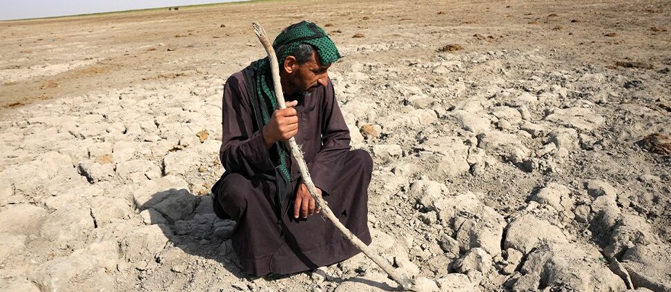 سەرەکی 13 A Marsh Arab man looks at a dry ground